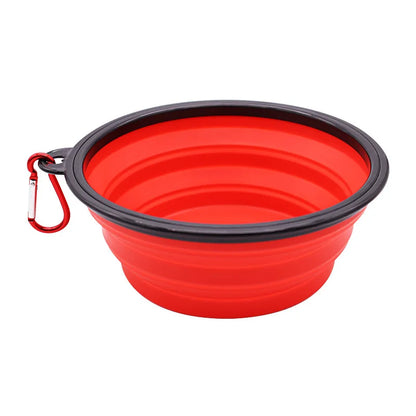Portable silicone dog feeder bowl with built-in water dispenser and carabiner for outdoor travel, suitable for dogs and cats.